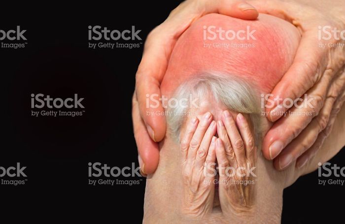 An old woman's face covered with hands photoshopped onto a hurting knee