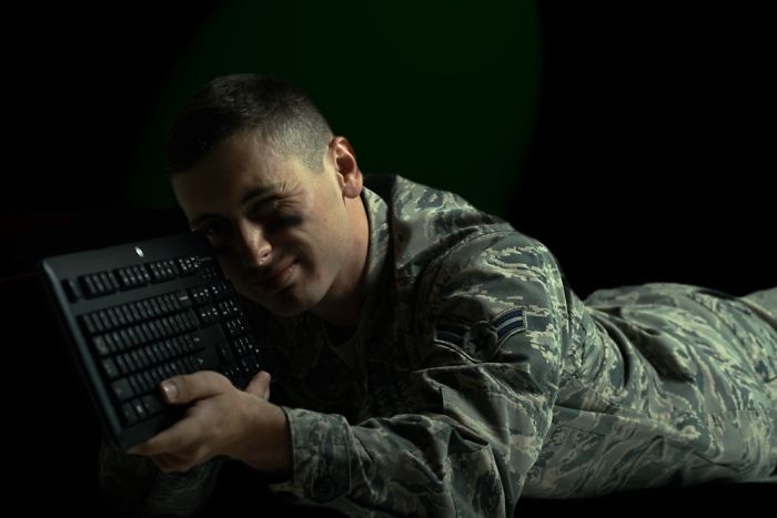 Young man in the army wear preparing to shoot with a keyboard
