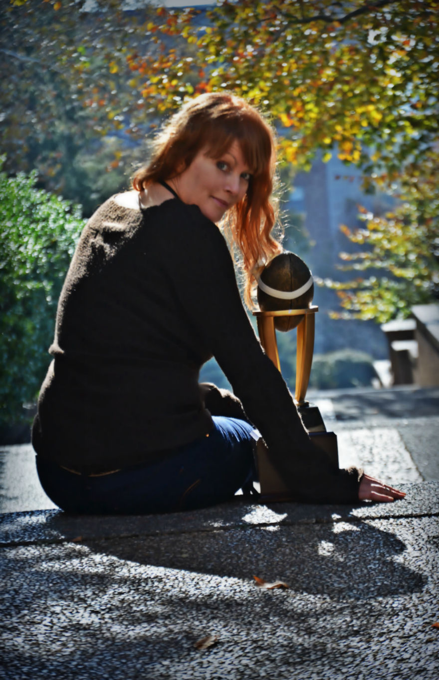 Woman Poses For Mommy-Baby Portraits With Fantasy Football Trophy Woman Poses For Mommy-Baby Portraits With Fantasy Football Trophy