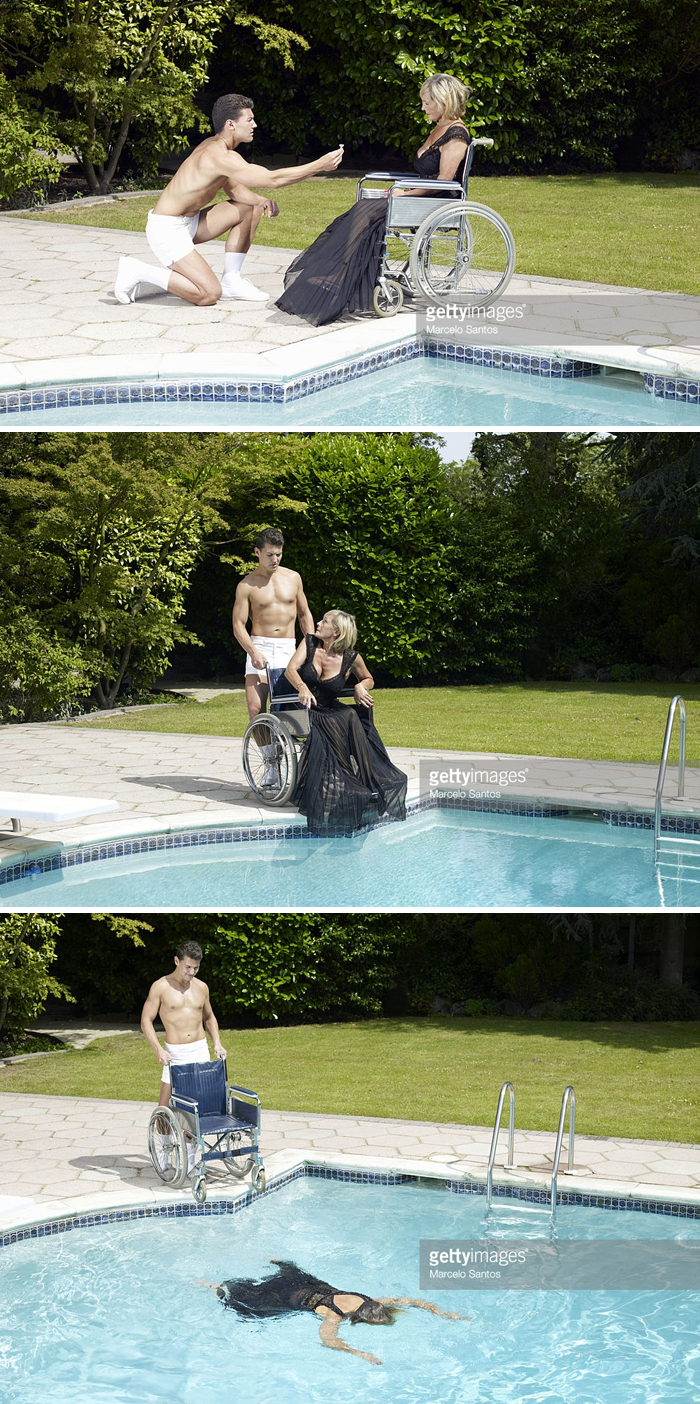 A man in shorts proposing to a woman in a wheelchair and then pushing her into a swimming pool