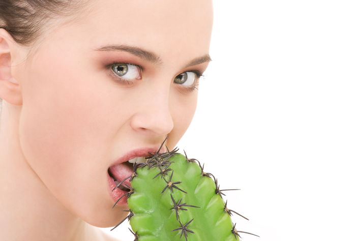 Woman licking a cactus