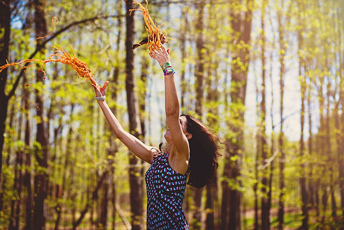 Woman Throwing Spaghetti In A Forest