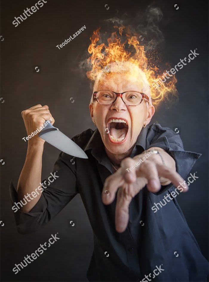A woman is angry with a knife in her hands and her head is on fire
