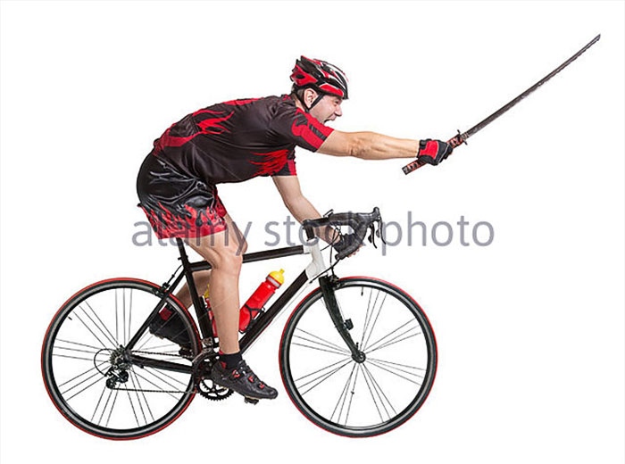Cyclist rides screaming and with a samurai sword in his hands