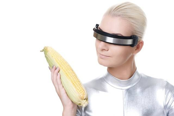 Cyber woman holding one corn and contemplating