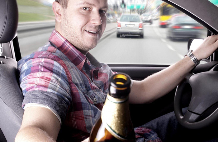 A man is drinking and driving