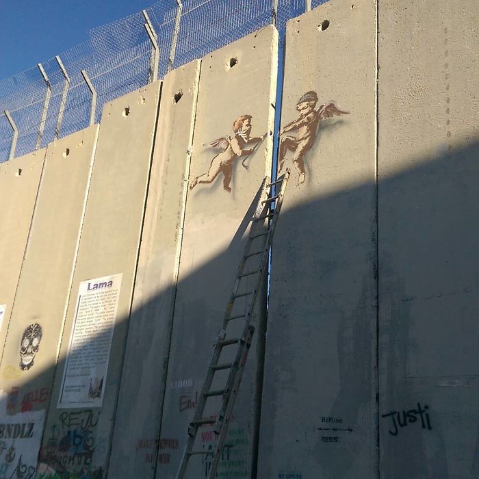 New Banksy Street Art In Palestine Reminds World That The Holidays Aren't Happy For Everyone