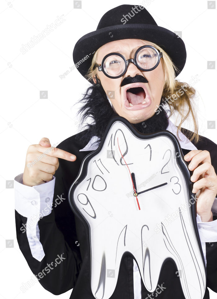 A woman dressed as a bearded Charlie Chaplin points at the melting clock with a terrified face