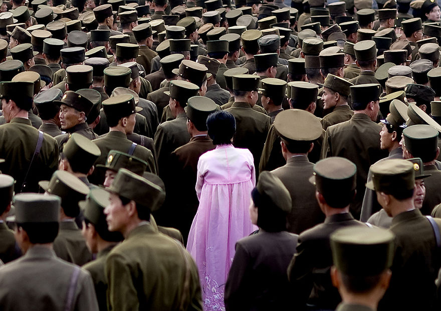 A Woman Standing In The Middle Of A Crowd Of Soldiers. This Picture Is Not Supposed To Be Taken As Officials Do Not Allow Army Pictures