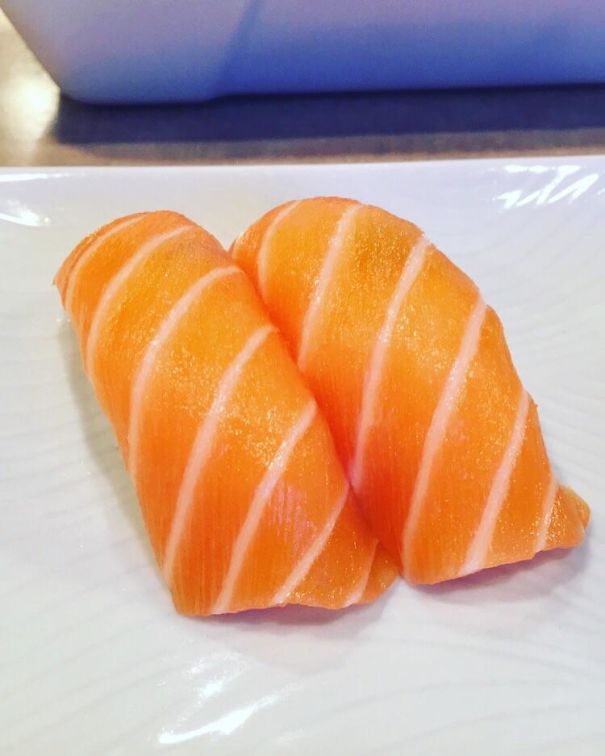 Two Perfect Slices Of Salmon Sashimi Over Rice