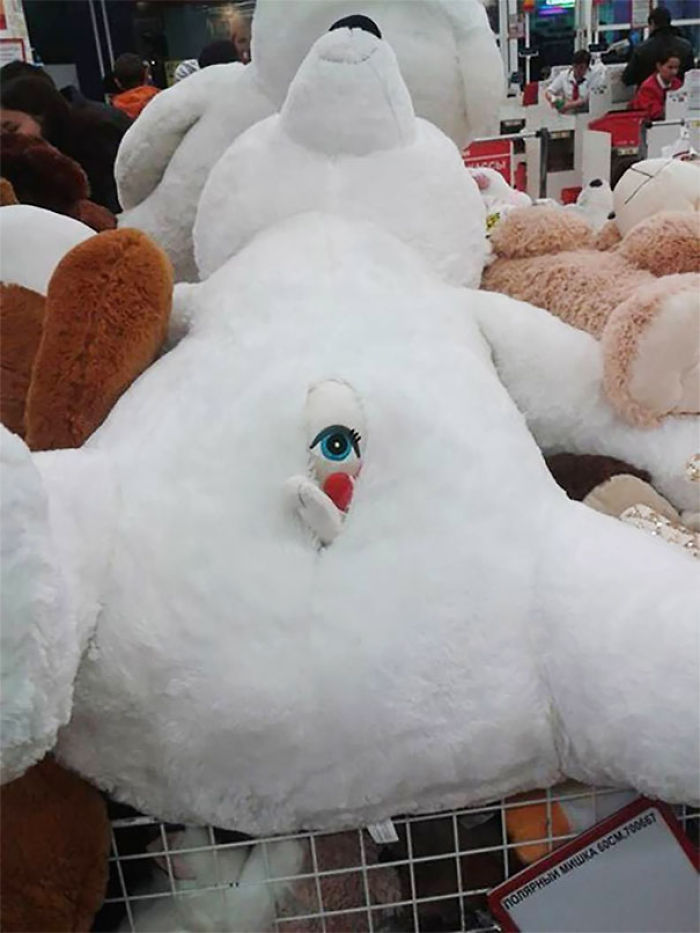 A large stuffed bear with a misplaced eye detail, illustrating a toy design fail.