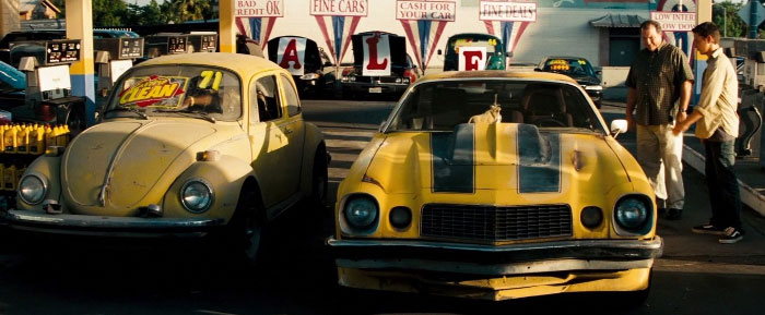 In Transformers, The First Time Bumblebee Appears, He's Parked Next To A Yellow Vw Beetle, His Original Form From The Cartoon Series And Toy Line