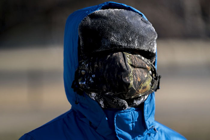 A Boy Has His Face Bundled Against Temperatures In Washington