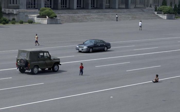 As Cars Have Become More Widespread In Pyongyang, The Peasants Are Still Getting Accustomed To Seeing Them. Kids Play In The Middle Of The Main Avenues Just Like Before When There Were No Cars In Sight
