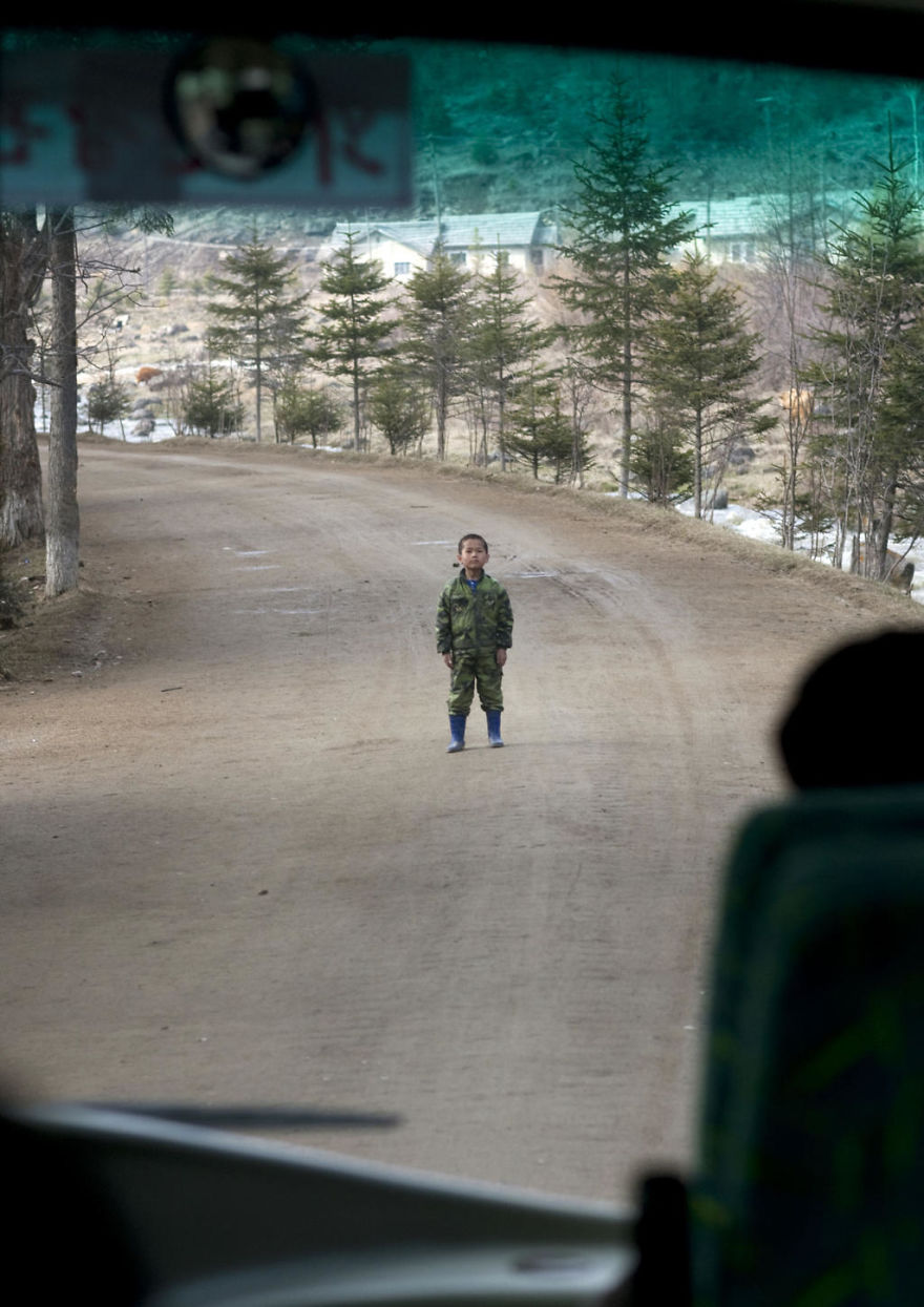 A Rare Example Of An Undisciplined Kid In North Korea. The Bus Was Driving In The Small Roads Of Samijyon In The North, When This Kid Stood In The Middle Of The Road