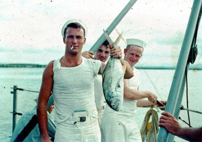 My Very Cool Grandpa In The 1950s Holding A Fish, Smoking A Cigarette, With A Book Tucked Into His Pants And Cigarette Pack In His Sleeve