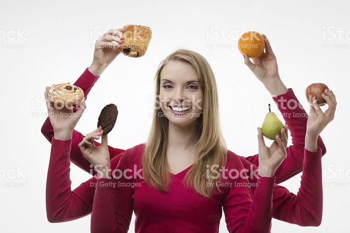 Happy woman with six arms holding fruits and cakes in each hand