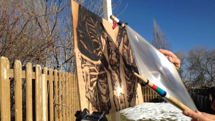 Artist Uses Sunlight To Burn Image Of Nephew Onto A Piece Of Wood