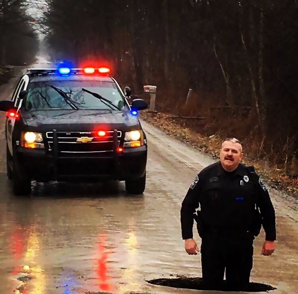 So We Found A Pothole. Just For A Little Perspective, Officer Clark Is 6'5"!