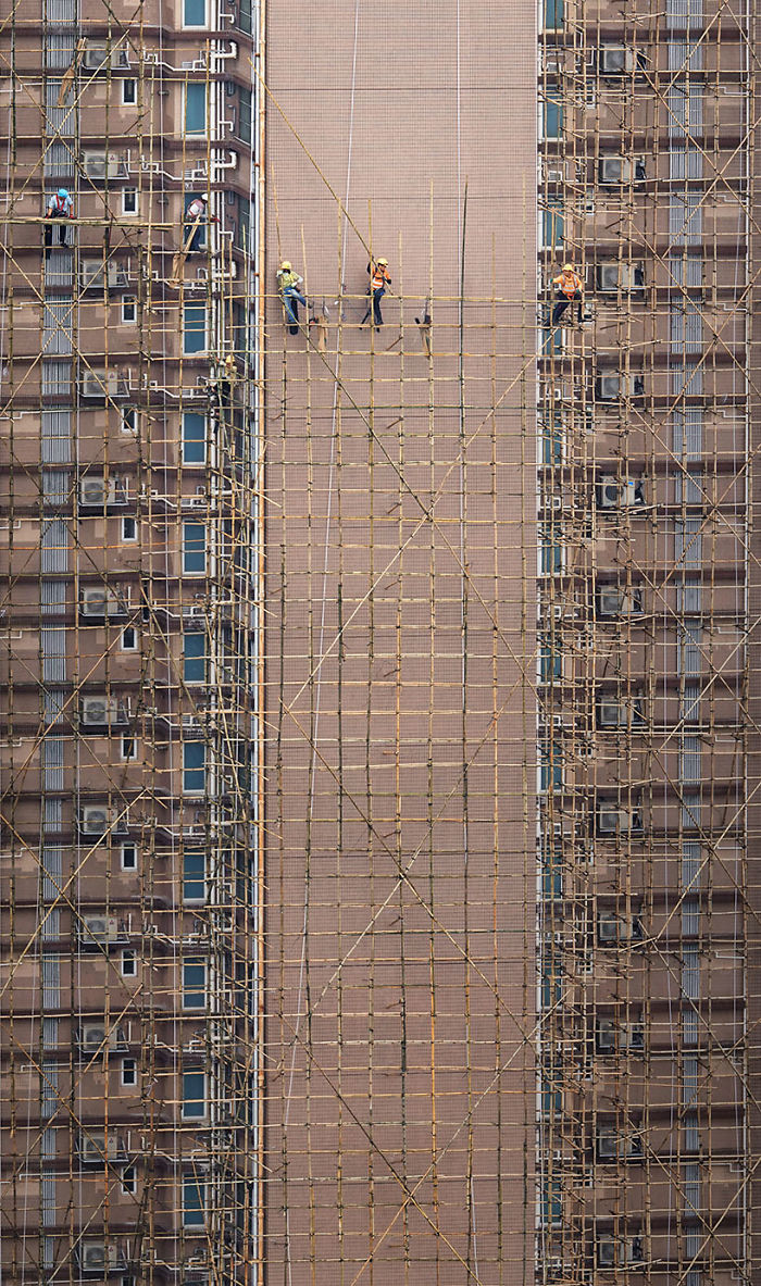 "Bamboo Weavers," Workers Are Setting Up The Bamboo Scaffolding That Will Be Used For The Building's Facade Restoration