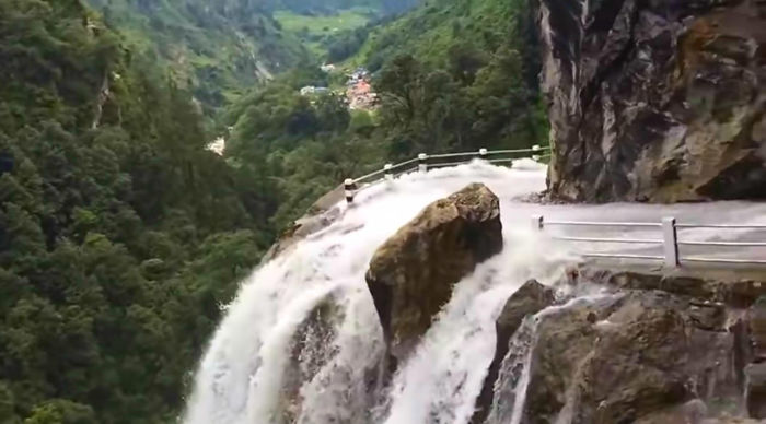 Driver Skillfully Navigates One Of The World's Most Dangerous Roads In Nepal That Runs Through A Waterfall