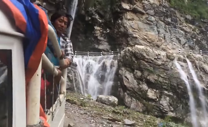 Driver Skillfully Navigates One Of The World's Most Dangerous Roads In Nepal That Runs Through A Waterfall