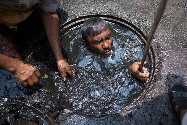 A Dhaka City Corporation Sewer Cleaner At Work, In Bangladesh