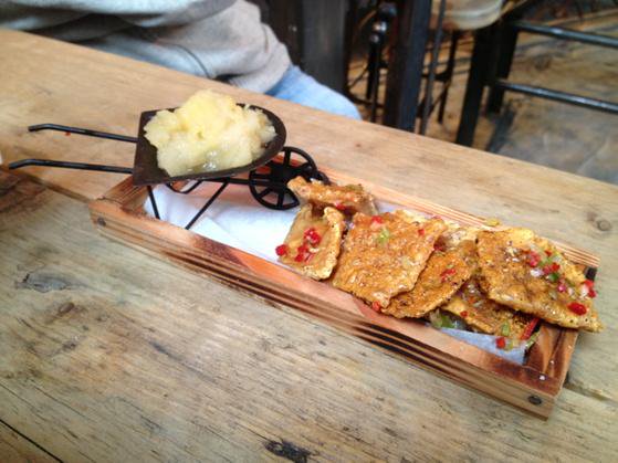 Pork Scratchings On A Plank, With A Mini Wheelbarrow Of Apple Sauce