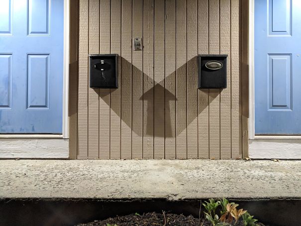 The Shadow Of Two Mailboxs Makes A Perfect Up Arrow