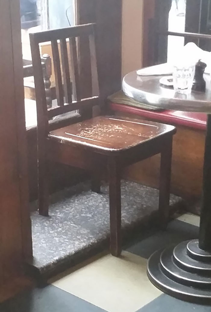 This Little Chair In A Café Has Its Back Legs Shortened To Fit On Top Of A Platform