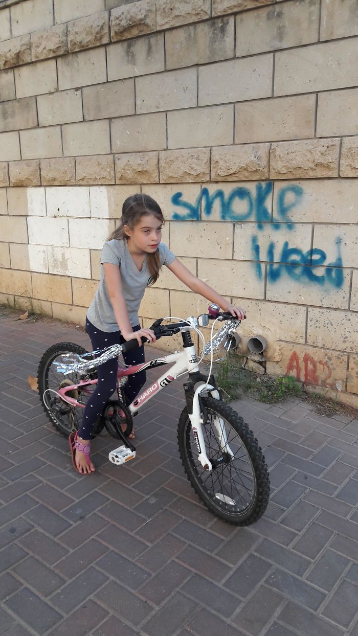 Took A Pic Of My Kid On Her New Pimped Up Bike... Didn't Pay Attention To The Graffiti In The Background