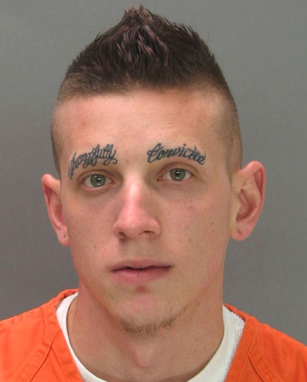 Lettering tattoos instead of eyebrows on young man