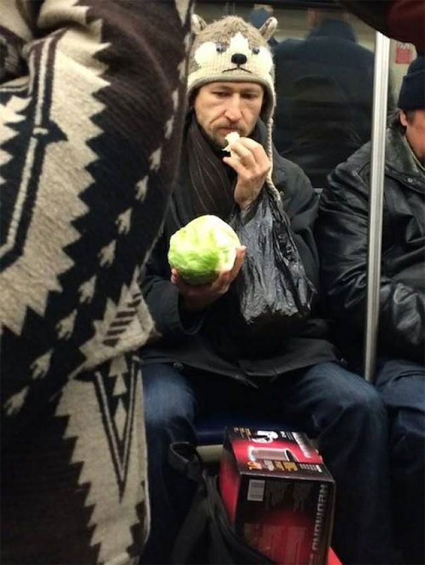 Subway Rider Eating A Head Of Lettuce