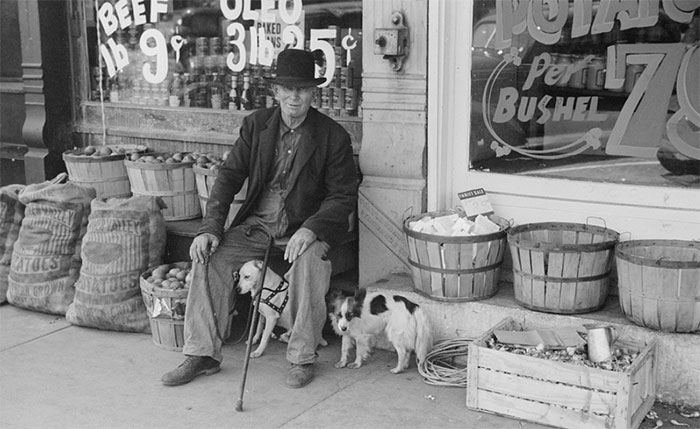 Man And Dogs In Front Of Grocery Store, Robinson, Illinois, 1940