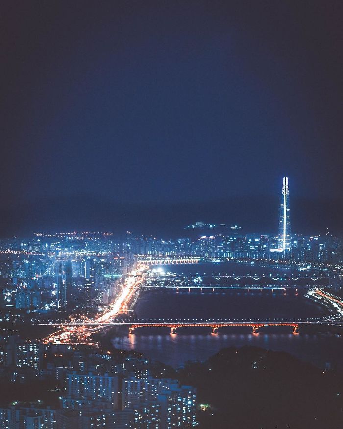Nighttime Seoul cityscape with illuminated bridges and tall buildings, highlighting life as an English teacher in Seoul.