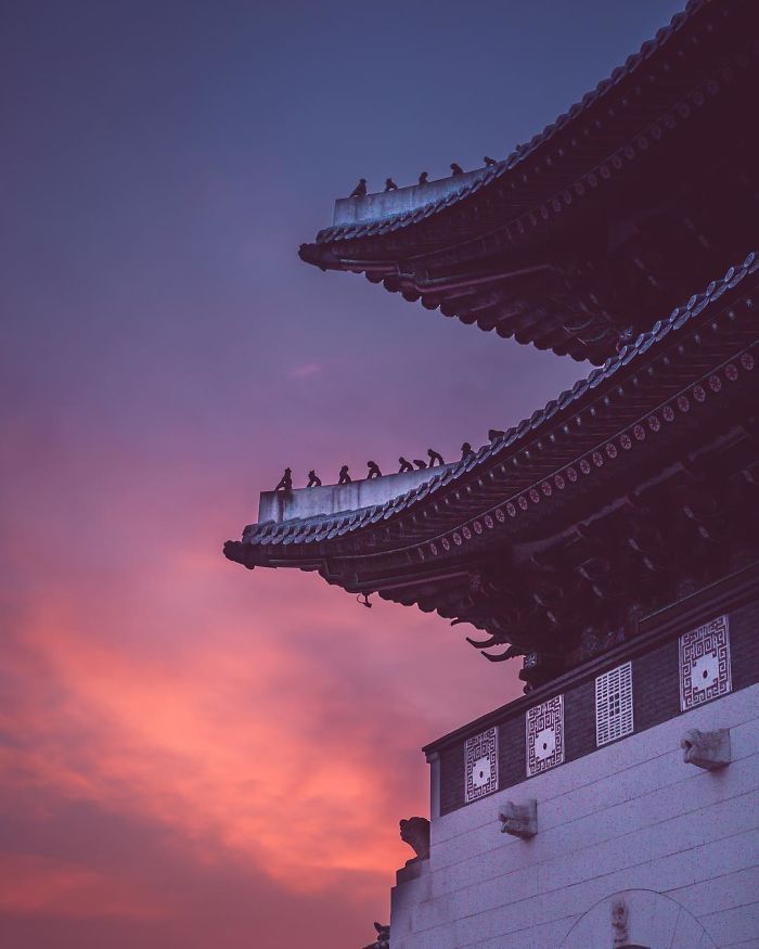 Traditional Korean building rooftop and architecture at sunset in Seoul, capturing the beauty of the city for an English teacher.