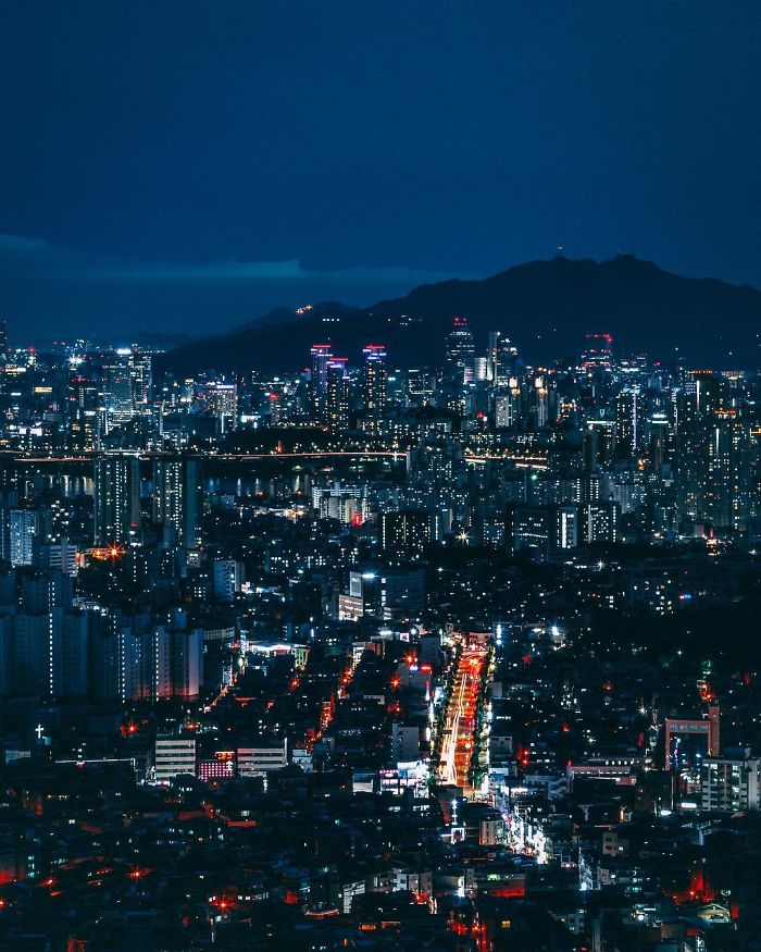 Nighttime cityscape of Seoul with illuminated buildings and streets, showcasing life of an English teacher living in Seoul.