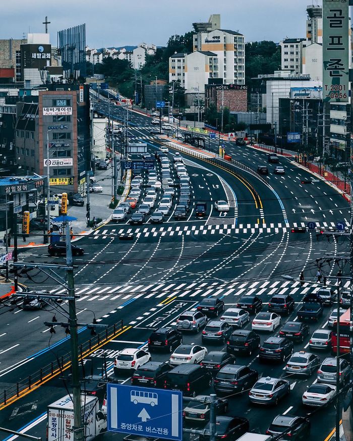 Busy Seoul city intersection with cars and buses, showcasing urban life captured by an English teacher in Seoul.