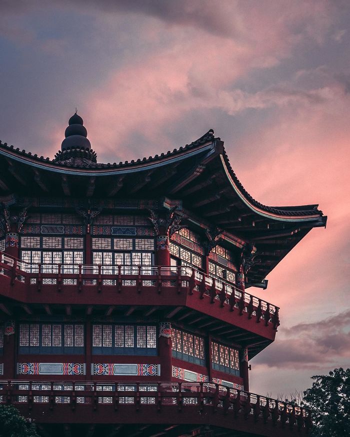 Traditional Korean architecture in Seoul at sunset, showcasing intricate wooden details and cultural heritage.