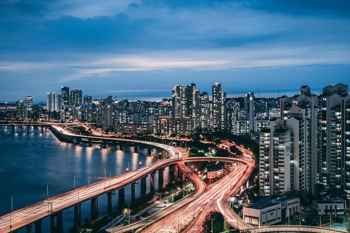 Night view of Seoul cityscape with illuminated bridges and high-rise buildings, capturing life of English teacher in Seoul.