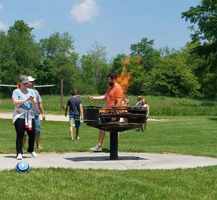 This Photo Of Me Standing Behind A Grill Looks Like I'm On Fire