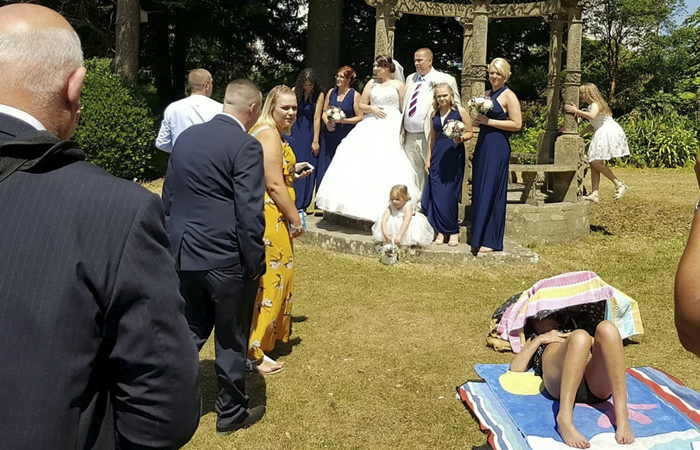 Couple Forced To Take Wedding Pics With Sunbathing Woman, And Internet Can’t Decide Who’s The Asshole