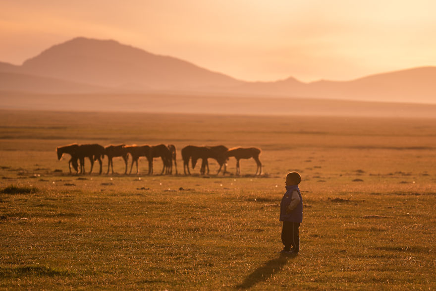 A Kid Of The Local Family Enjoying The Sunset At Song-Kul