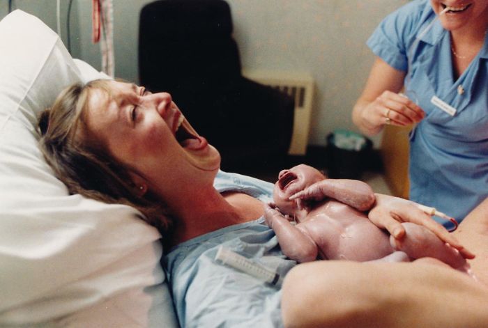 Moments After Giving Birth A Mother Laughs Hysterically At Her Husband Who Just Fainted At The Sight Of Their Newborn Son, 1986