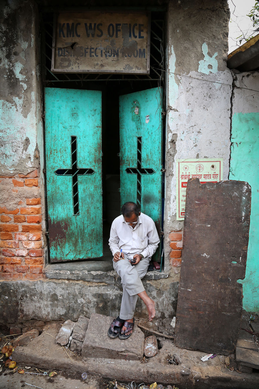 A Man Checks His Mobile Phone In A Street Near Howrah Station In Kolkata, India