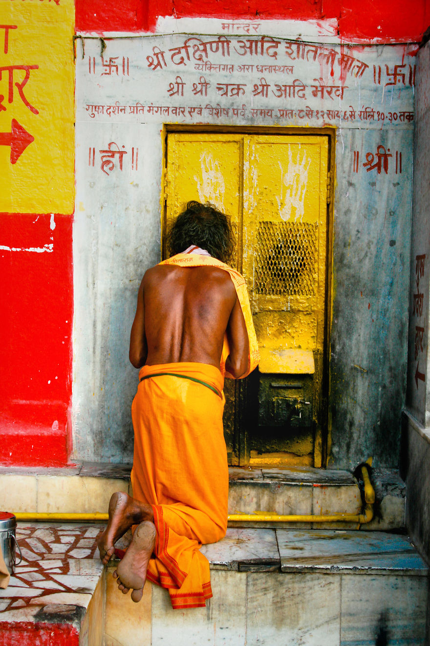A Man Prays At The Door Of A Temple Of The Legendary City Varanasi, India