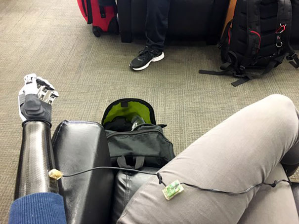 "Forgot To Charge Arm Last Night. Charging At Cellphone Charge Area At Airport" Angel Giuffria