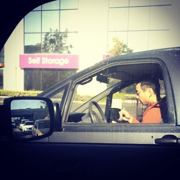 Distracted Drivers Are Everywhere, But When On The Roads In LA You Have To Step It Up. Here Is A Guy Eating A Noodle Bowl With Chopsticks While Driving No Handed And Looking Down