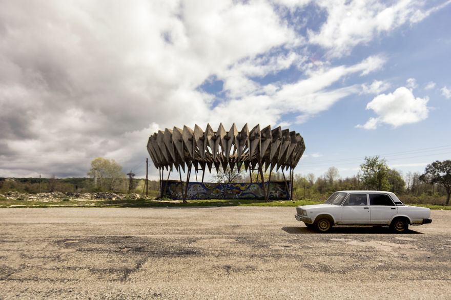 A Soviet Bus Stop Is Passed By A Soviet Car