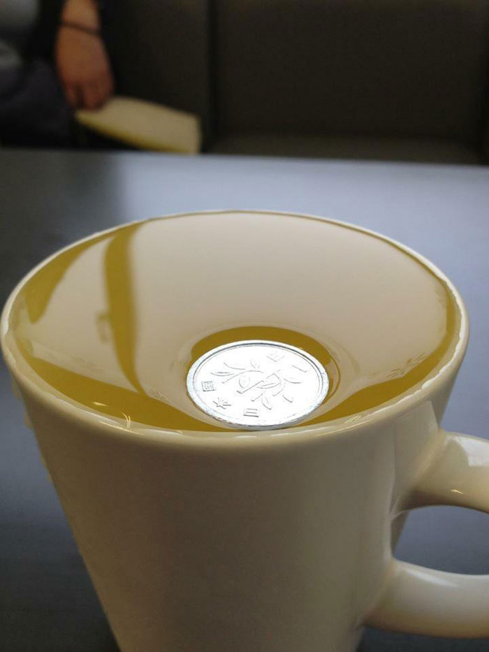 A Japanese 1 Yen Coin Is So Light It Won't Even Break Surface Tension On Water